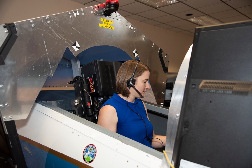 NASA's 2017 astronaut candidate Kayla Barron practices flying in an X-59 QueSST simulator at Armstrong Flight Research Center,