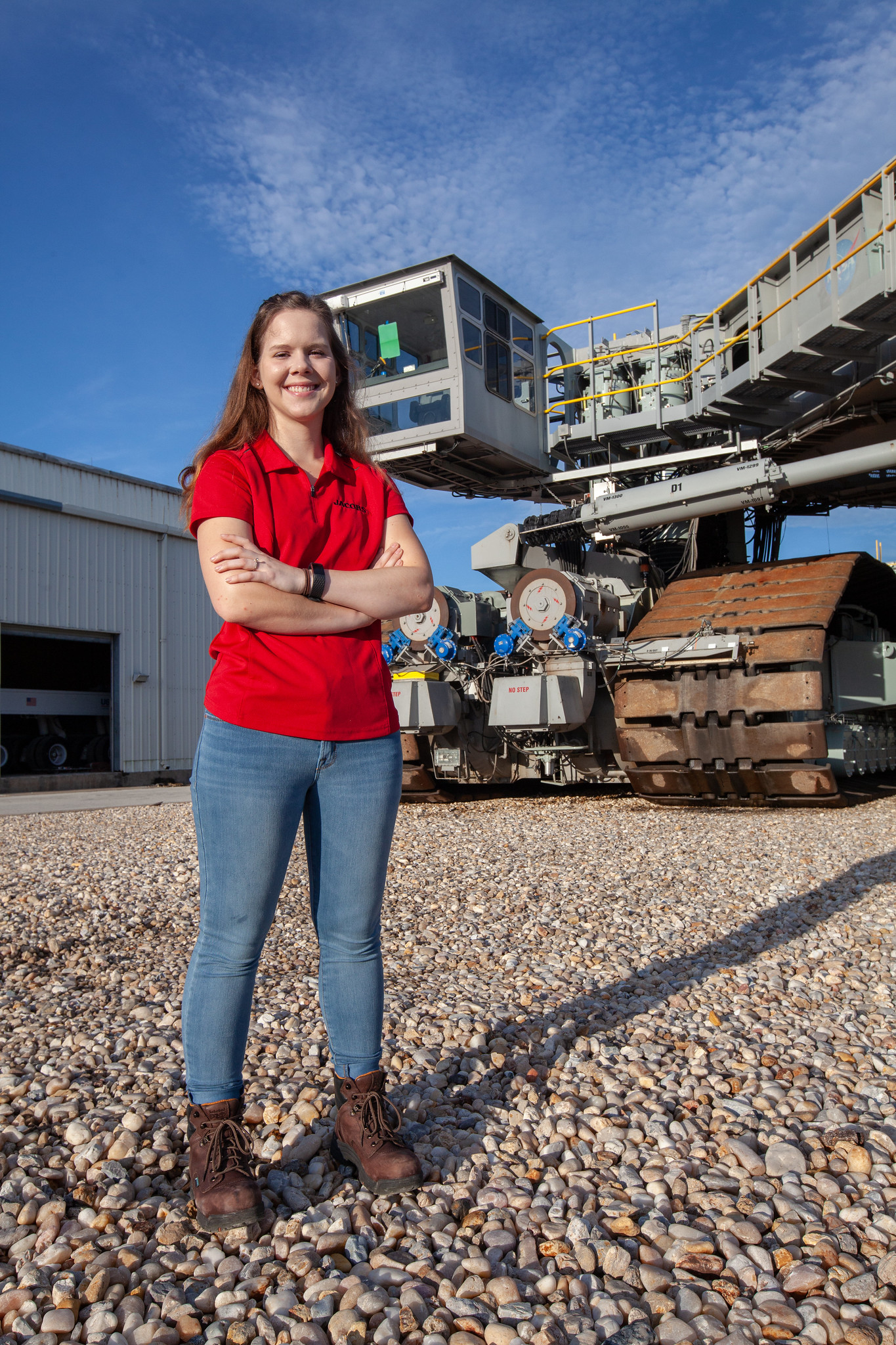 Breanne Stichler, mechanical engineer I, is photographed in front of NASA’s Crawler-Transporter 2. 