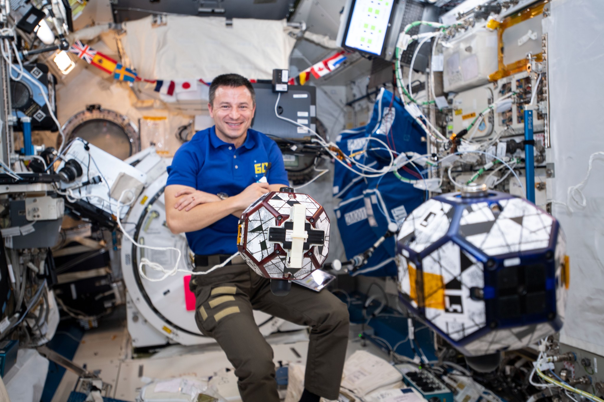 NASA astronaut Andrew Morgan monitors SPHERES satellites