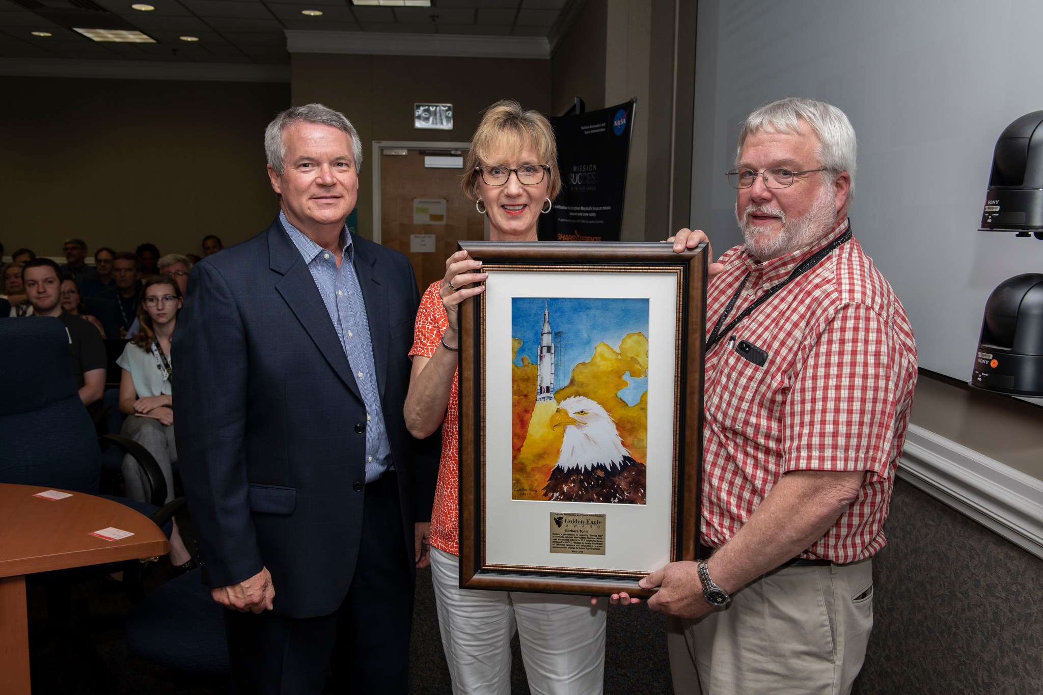 Barbara Tonn, center, receives a Golden Eagle award from Randy Lycans, left, and Pete Allen.