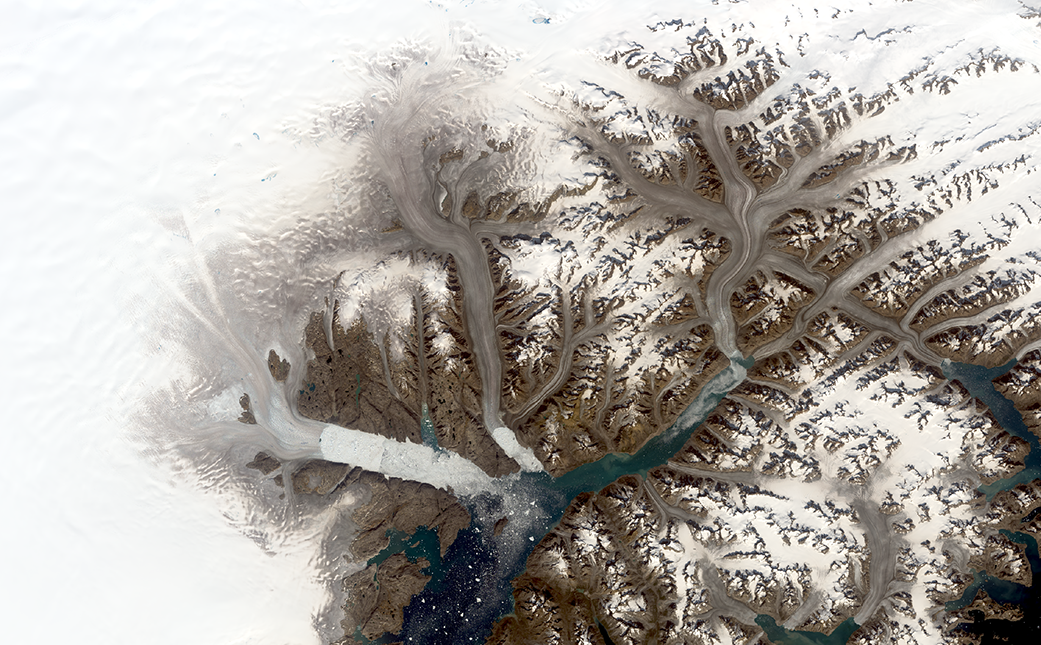 A satellite image from 2019 shows the same region with glaciers retreating and more visible rock.