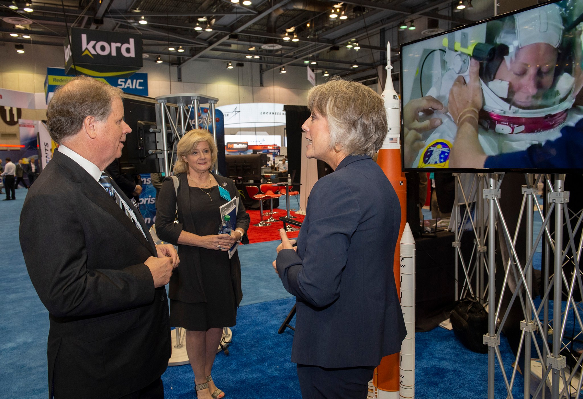 U.S. Sen. Doug Jones of Alabama, left, and Jody Singer, center, talk with Marcia Lindstrom on Aug. 7.