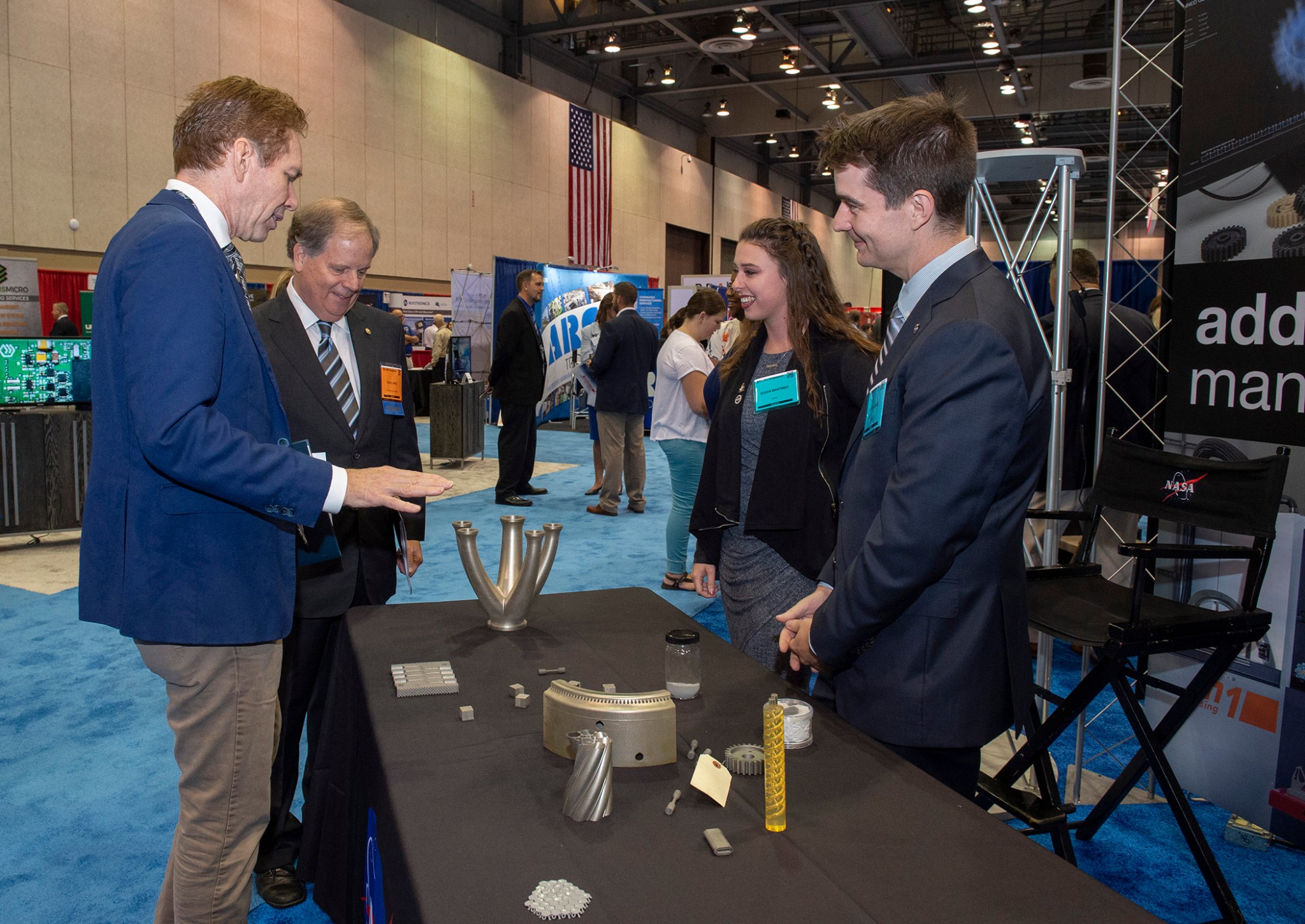 Marshall Deputy Director Paul McConnaughey, left, discusses advanced manufacturing capabilities with Jones, second from left.