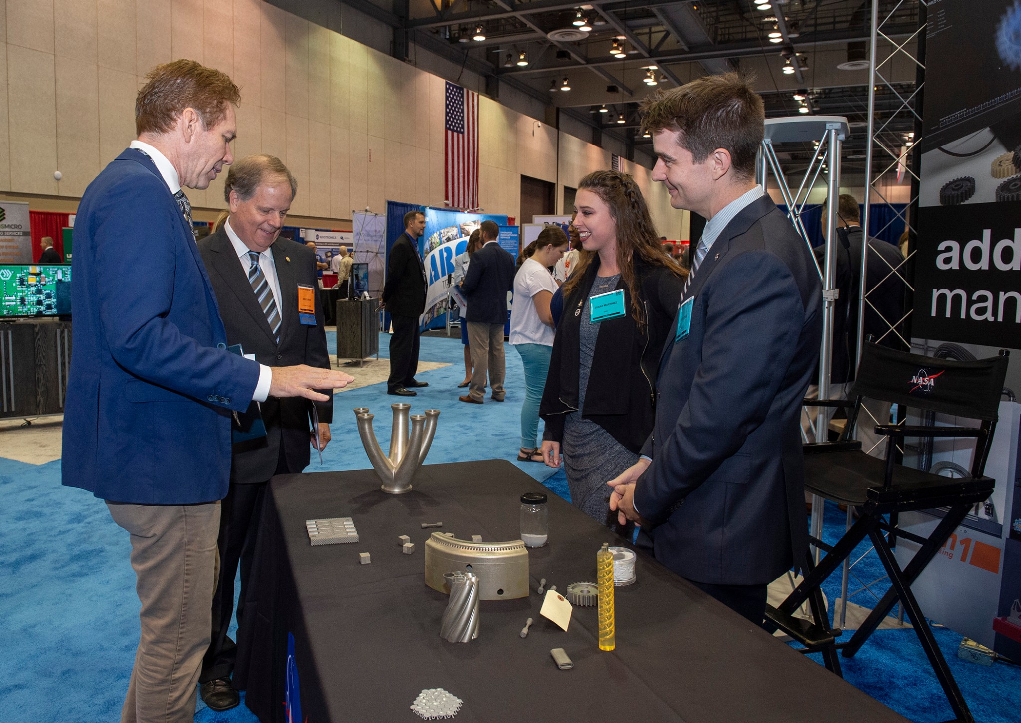 Marshall Deputy Director Paul McConnaughey, left, discusses advanced manufacturing capabilities with Jones, second from left. 