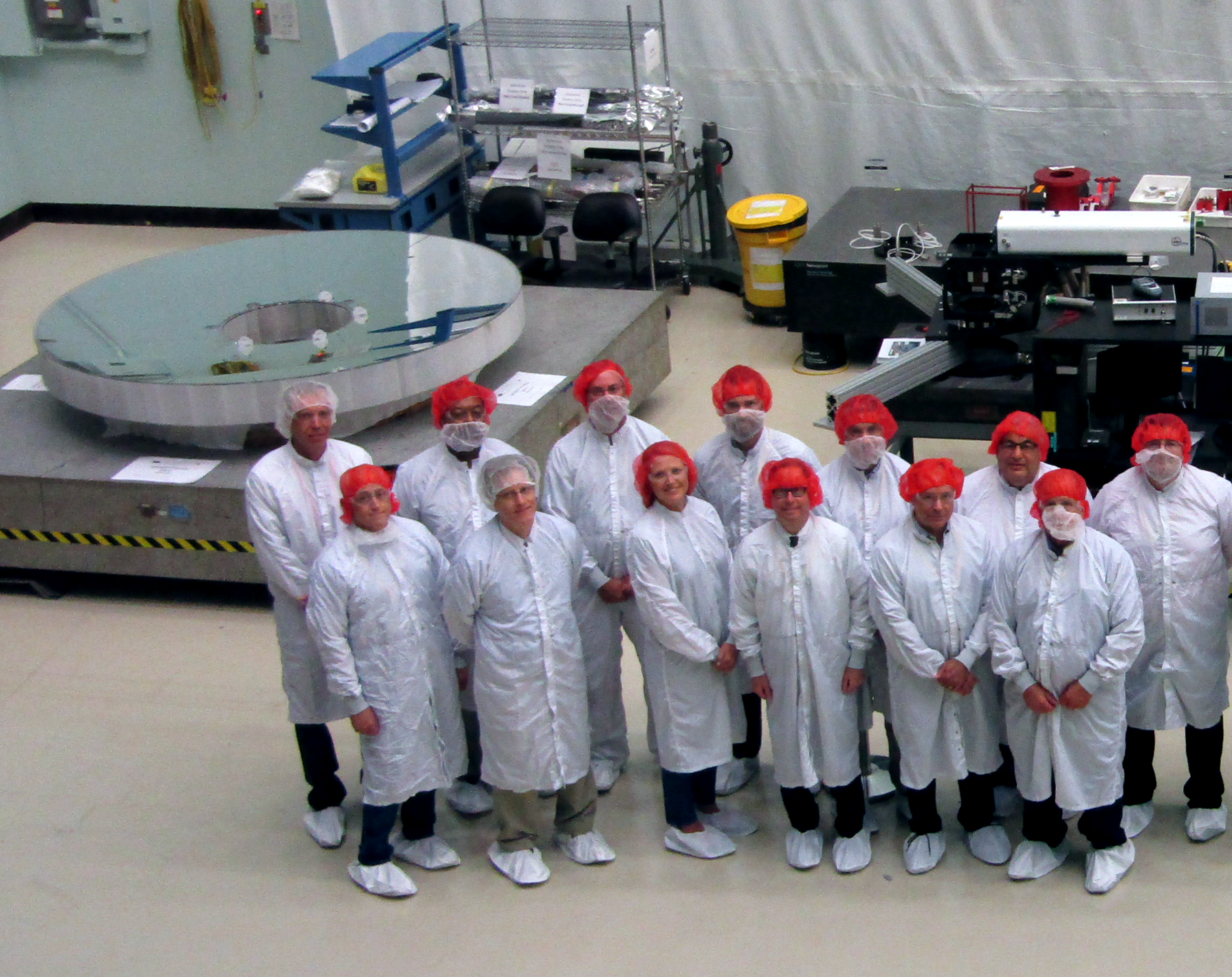 WFIRST team pose with telescope's primary mirror