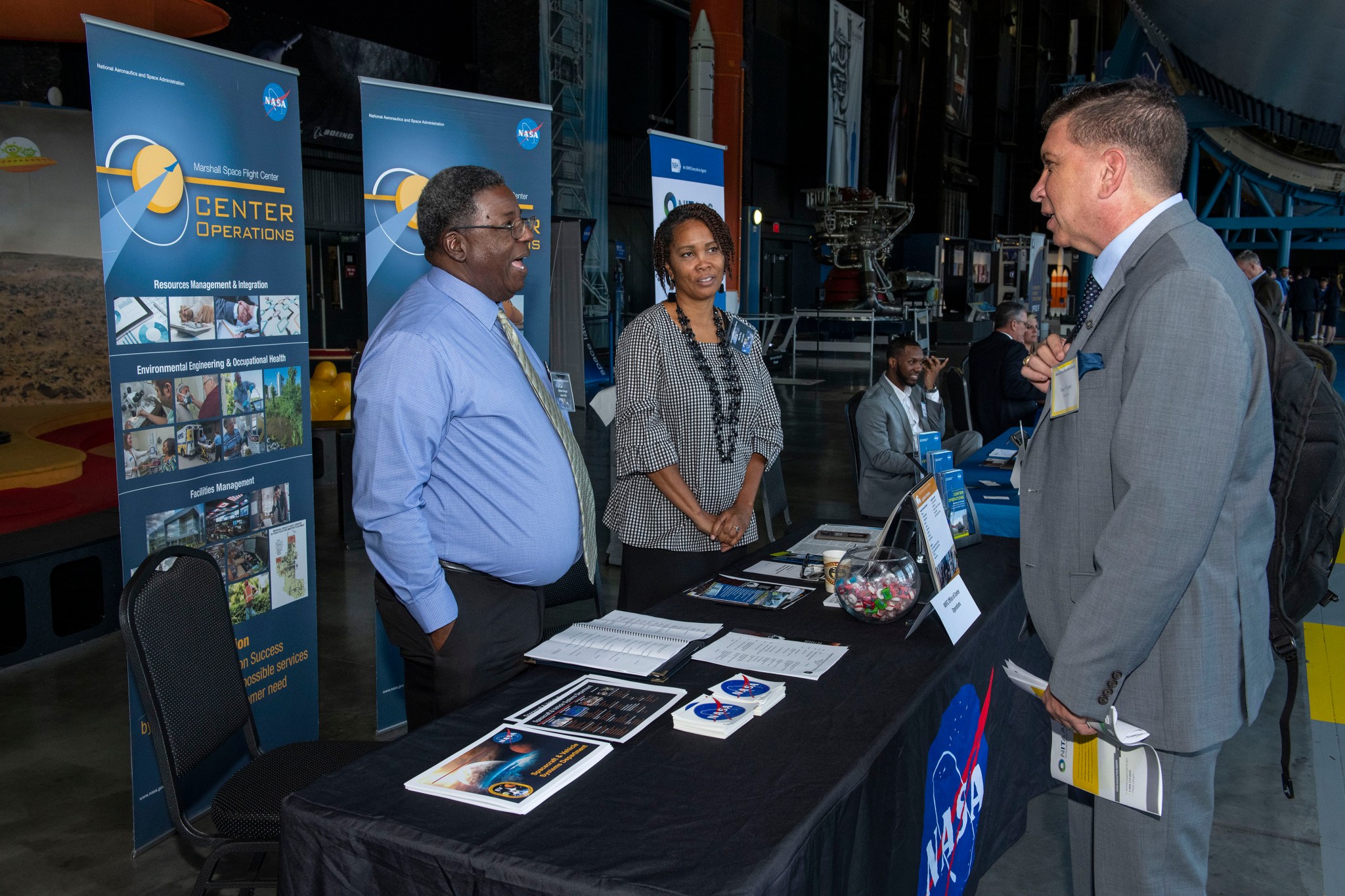 Melvin Scruggs, left, and Mary Poe speak with an attendee at the Small Business Alliance Meeting on Sept. 19.