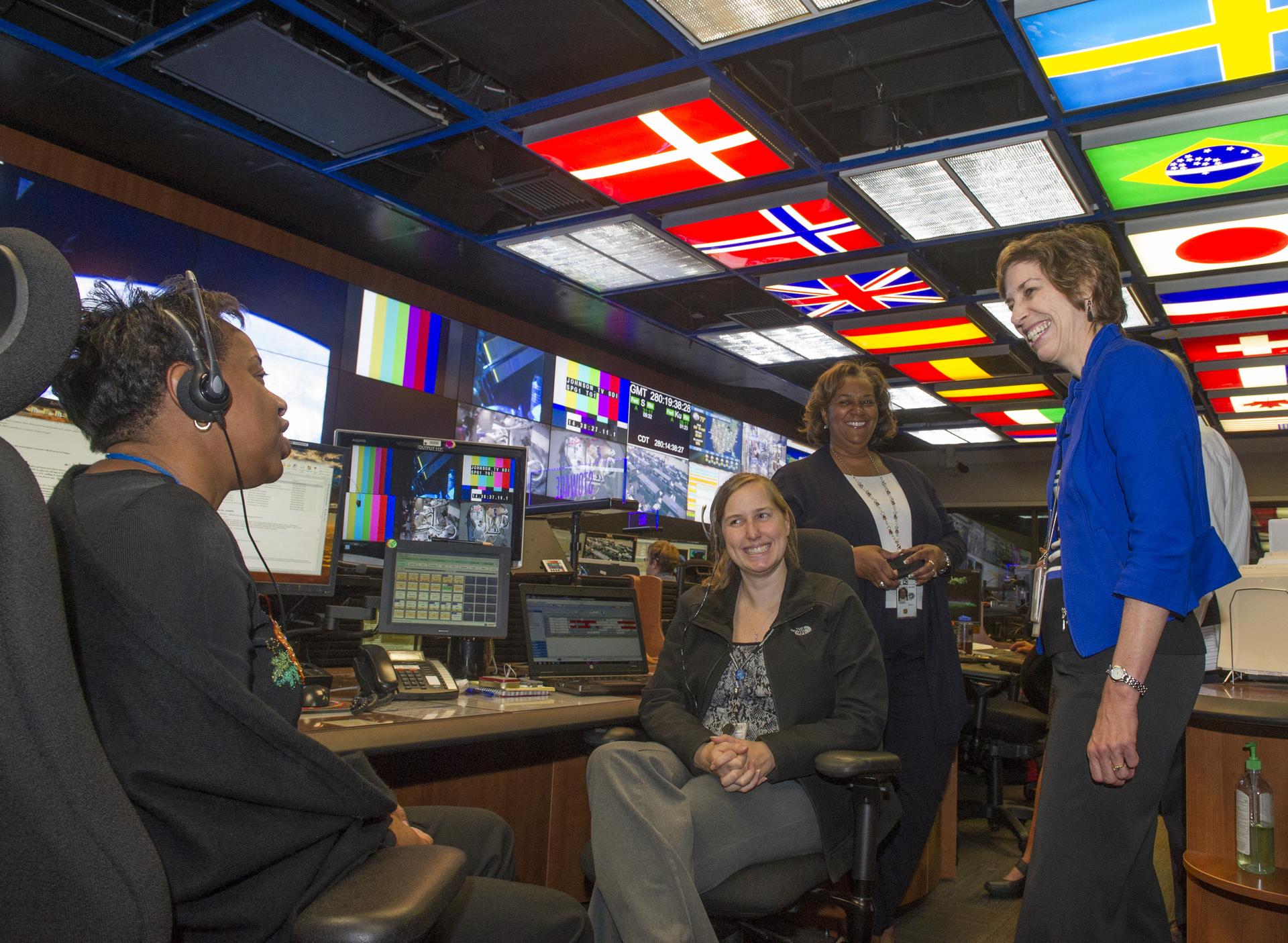 Former Johnson Center Director Ellen Ochoa, right, visits with members of the Payload Operations Integration Center.