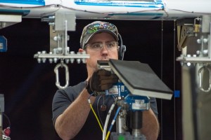 Ray Sadler adjusts hydraulic actuators with pads to the wing of the X-57 distributed electric aircraft wing.