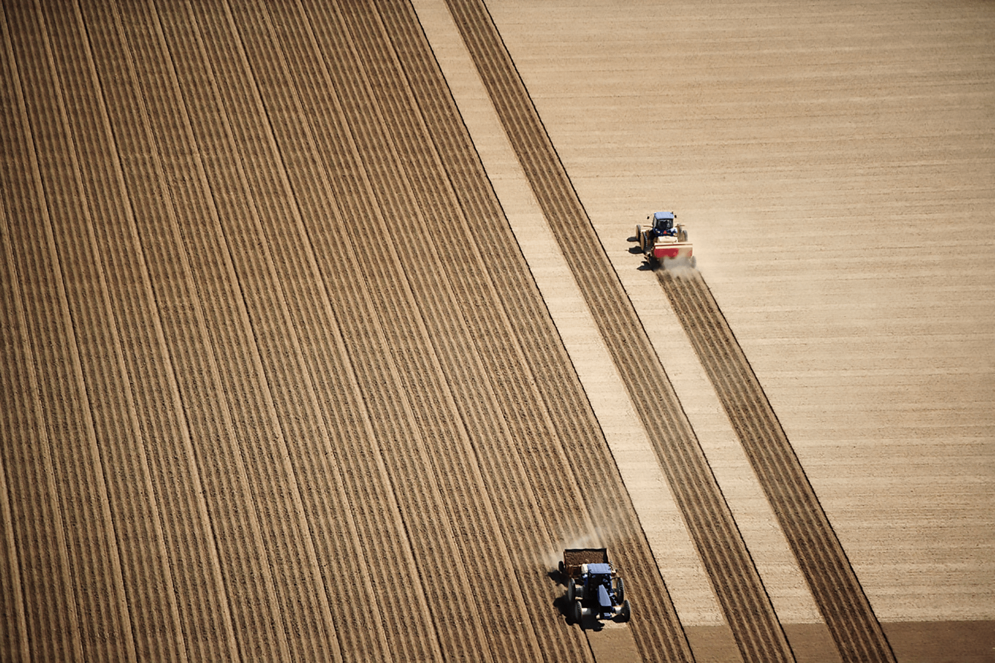 Farmers driving tractors.