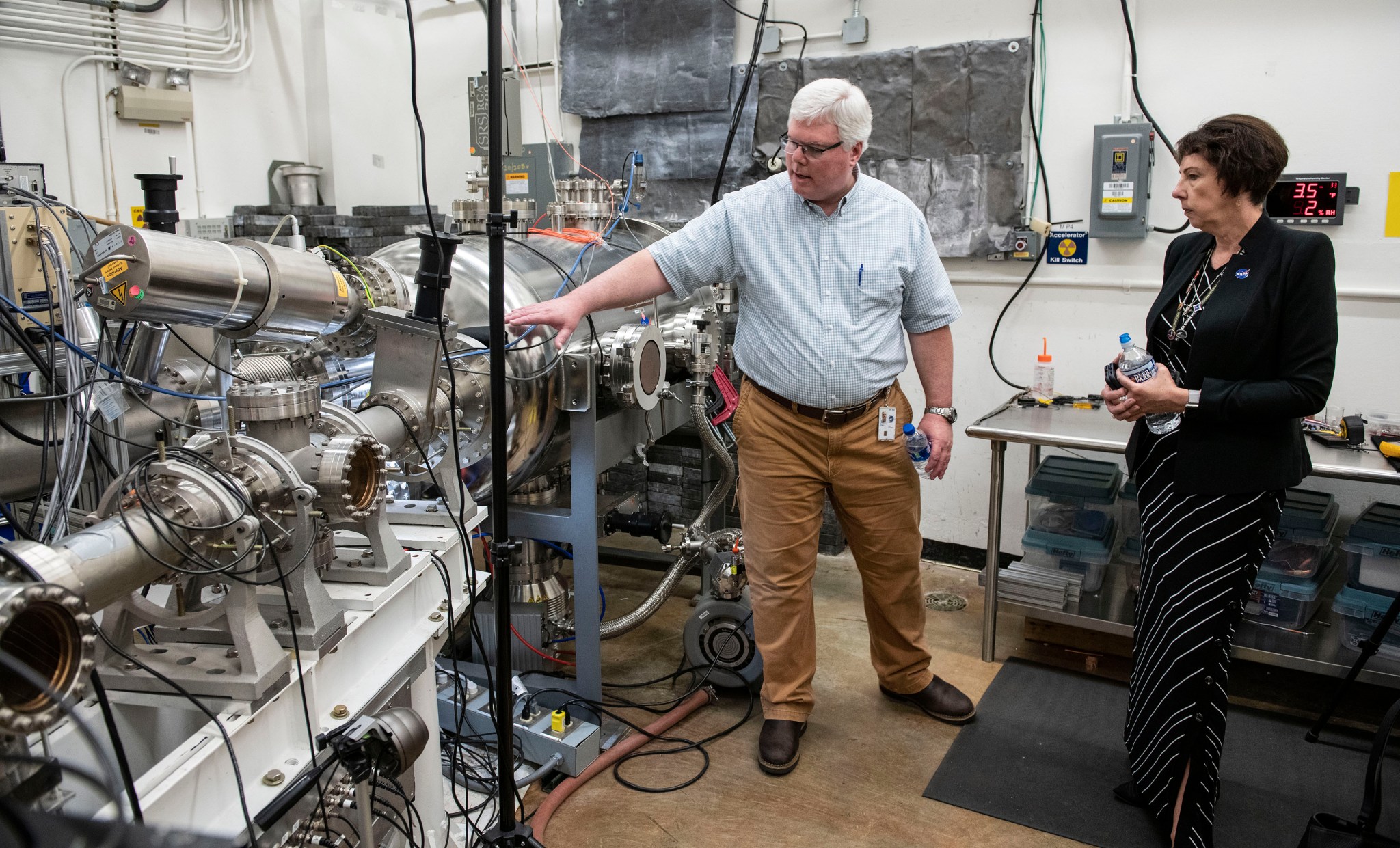 Nicola Fox hears from NASA’s Marshall Space Flight Center physicist Todd Schneider during her visit to the center Sept. 26.