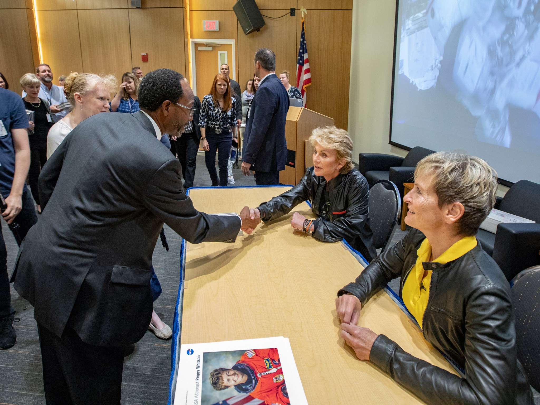 NASA Langley Center Director Clayton Turner greets Cornwell and Whitson after the question-and-answer session.