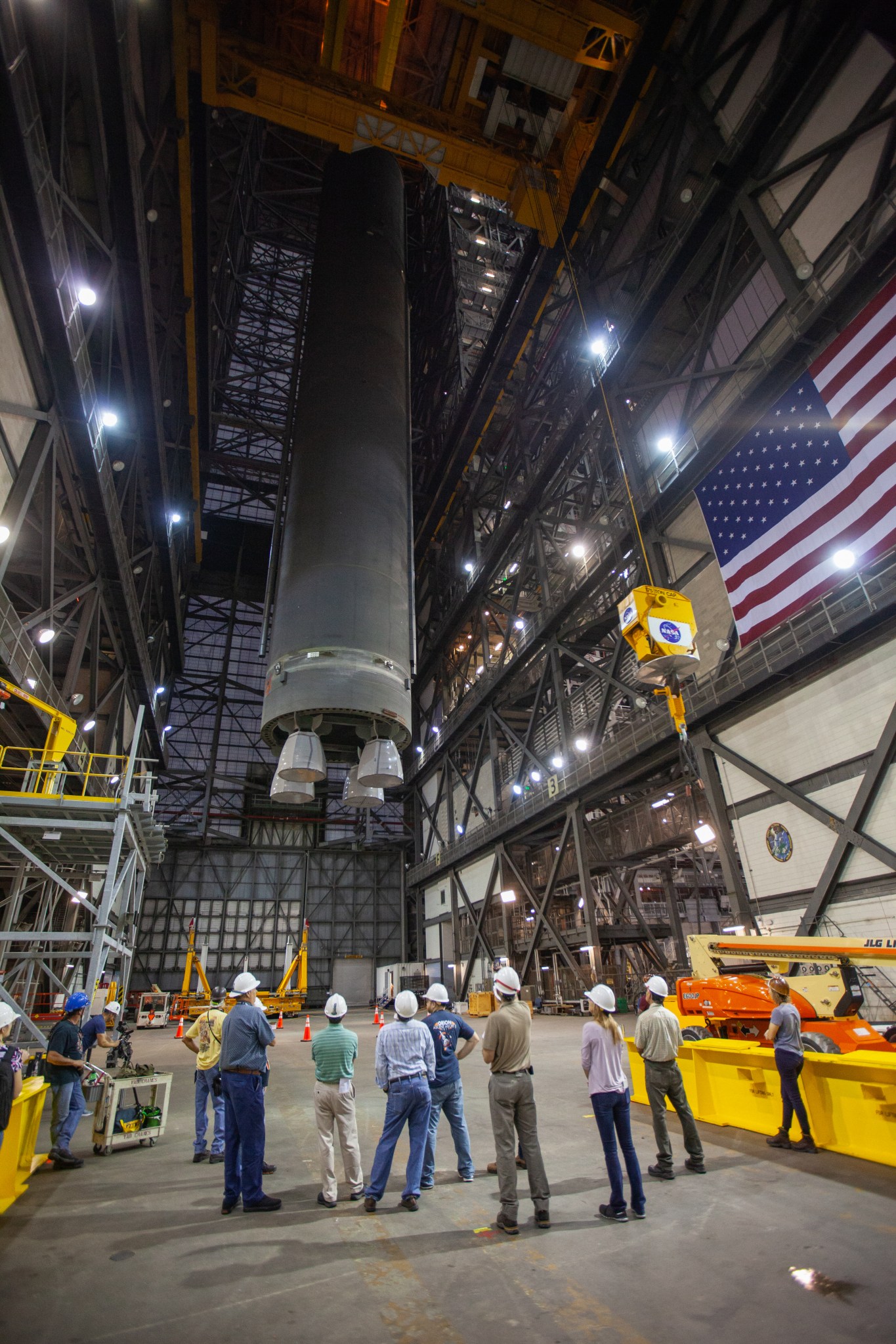 The SLS core stage pathfinder is lifted into the vertical position in the transfer aisle of the Vehicle Assembly Building.