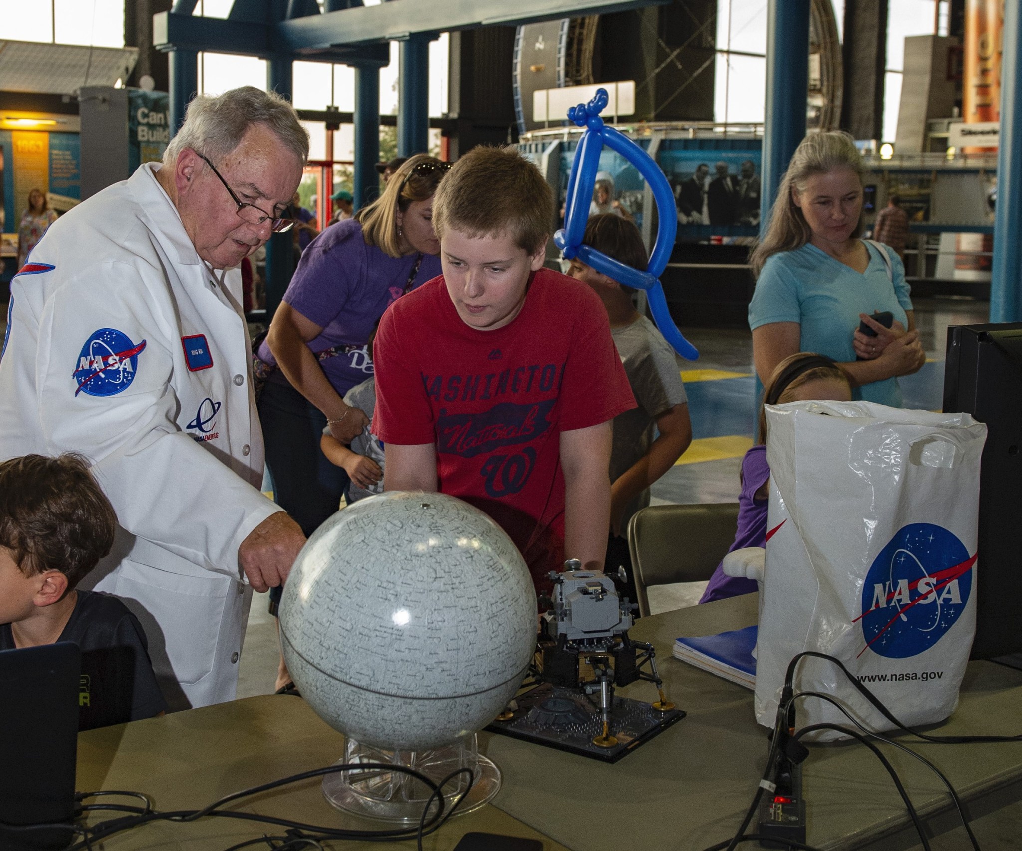 Retired NASA space thermal and systems engineer Ron Creel, left, gives visitor Caiden Williams a lunar geography lesson Oct. 5.
