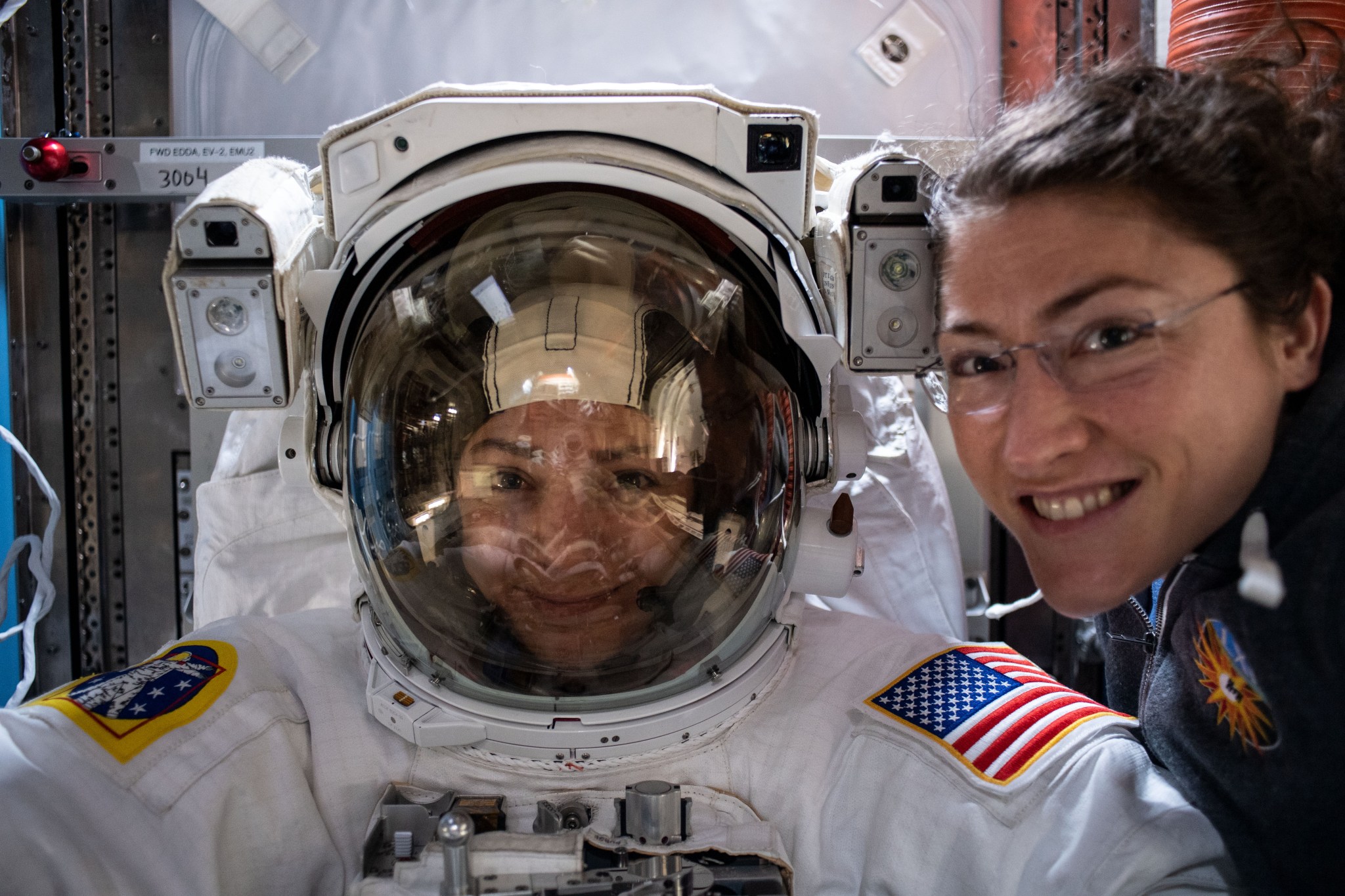 NASA astronauts Christina Koch and Jessica Meir prepare for a spacewalk