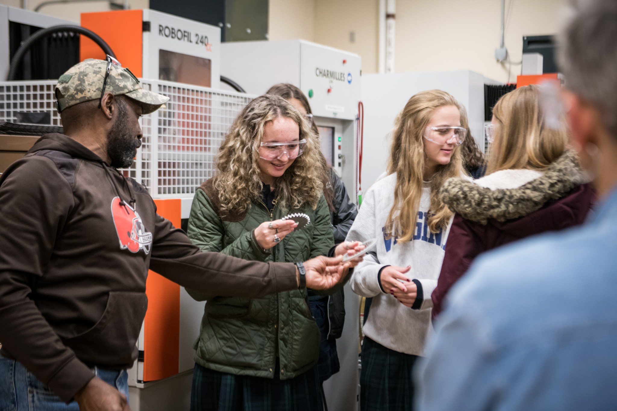 Henry Scott, discusses a sample spur gear with students.