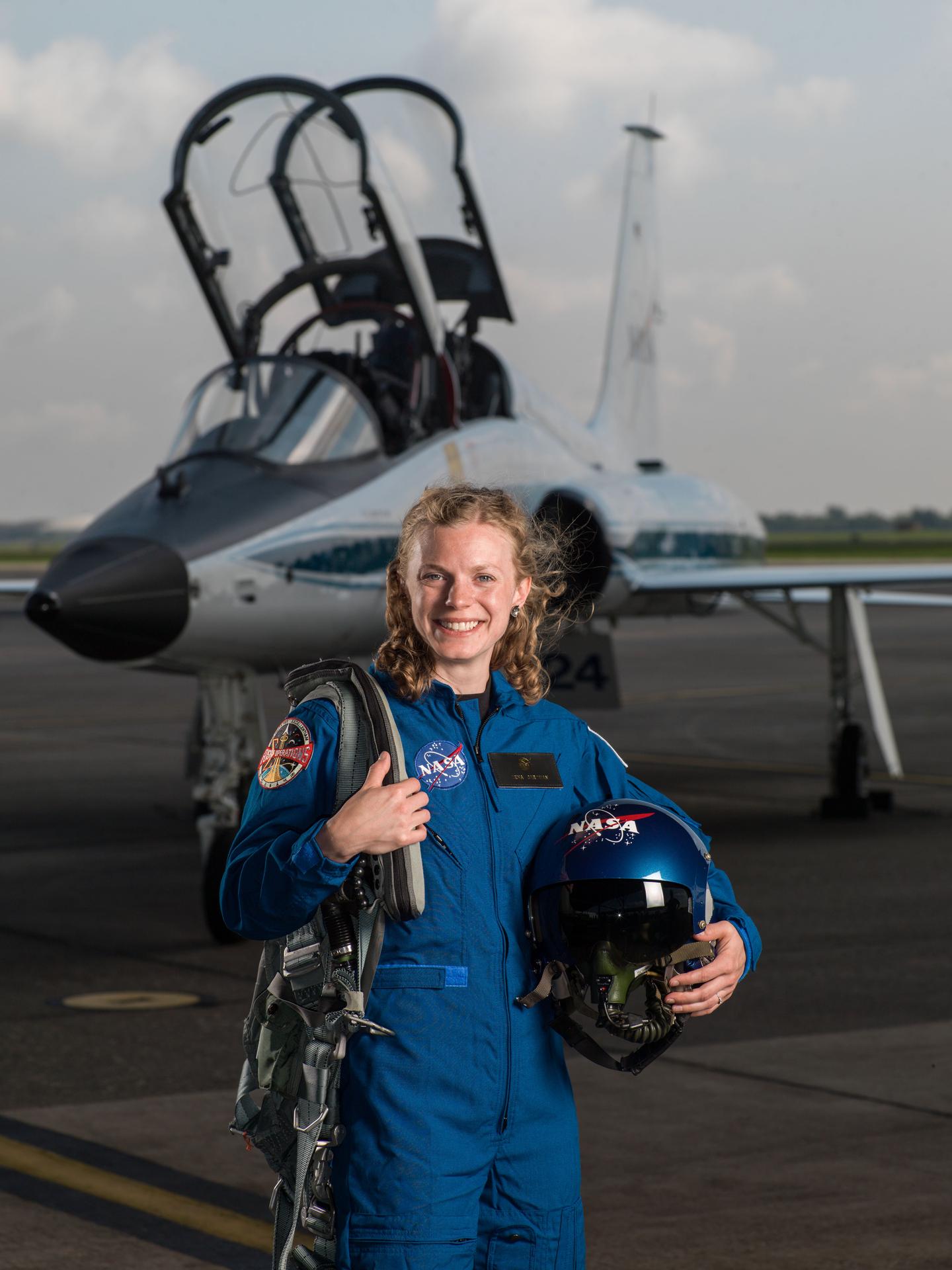 NASA portrait of 2017 Astronaut Candidate Zena Cardman in front of a T-38 trainer aircraft at Ellington Field