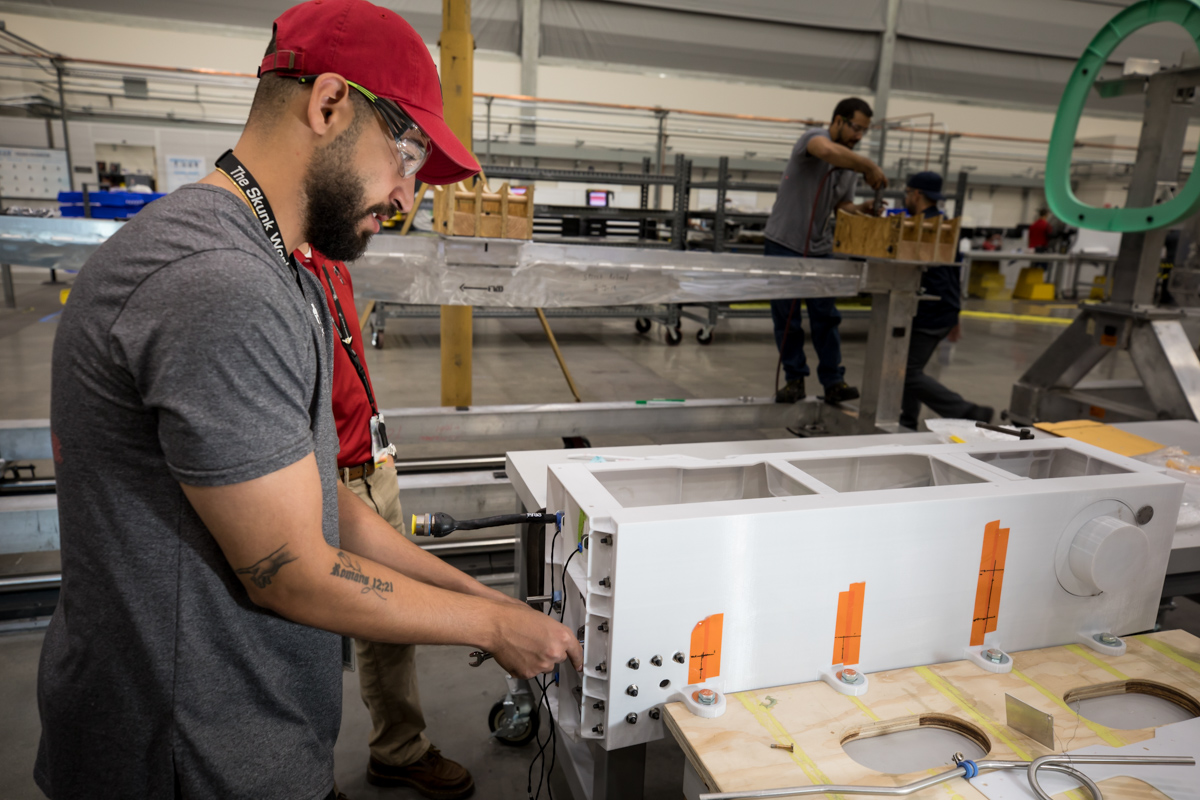 A Lockheed Martin technician works with a mockup.