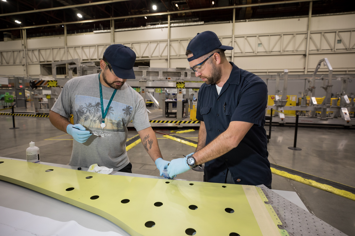 Lockheed Martin technicians working on the wing spar for NASA's X-59.