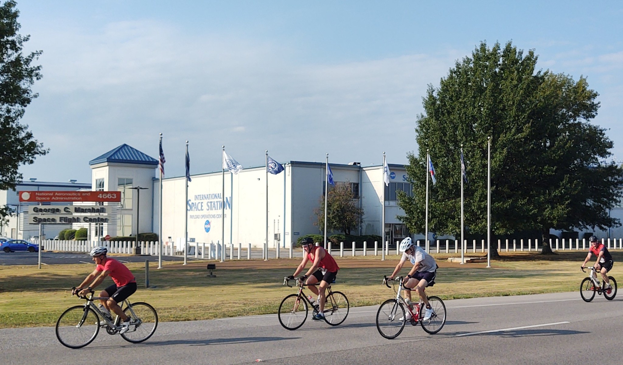 Cyclists pass Marshall’s Payload Operations Center in the second leg of the 2019 Racin’ the Station duathlon.