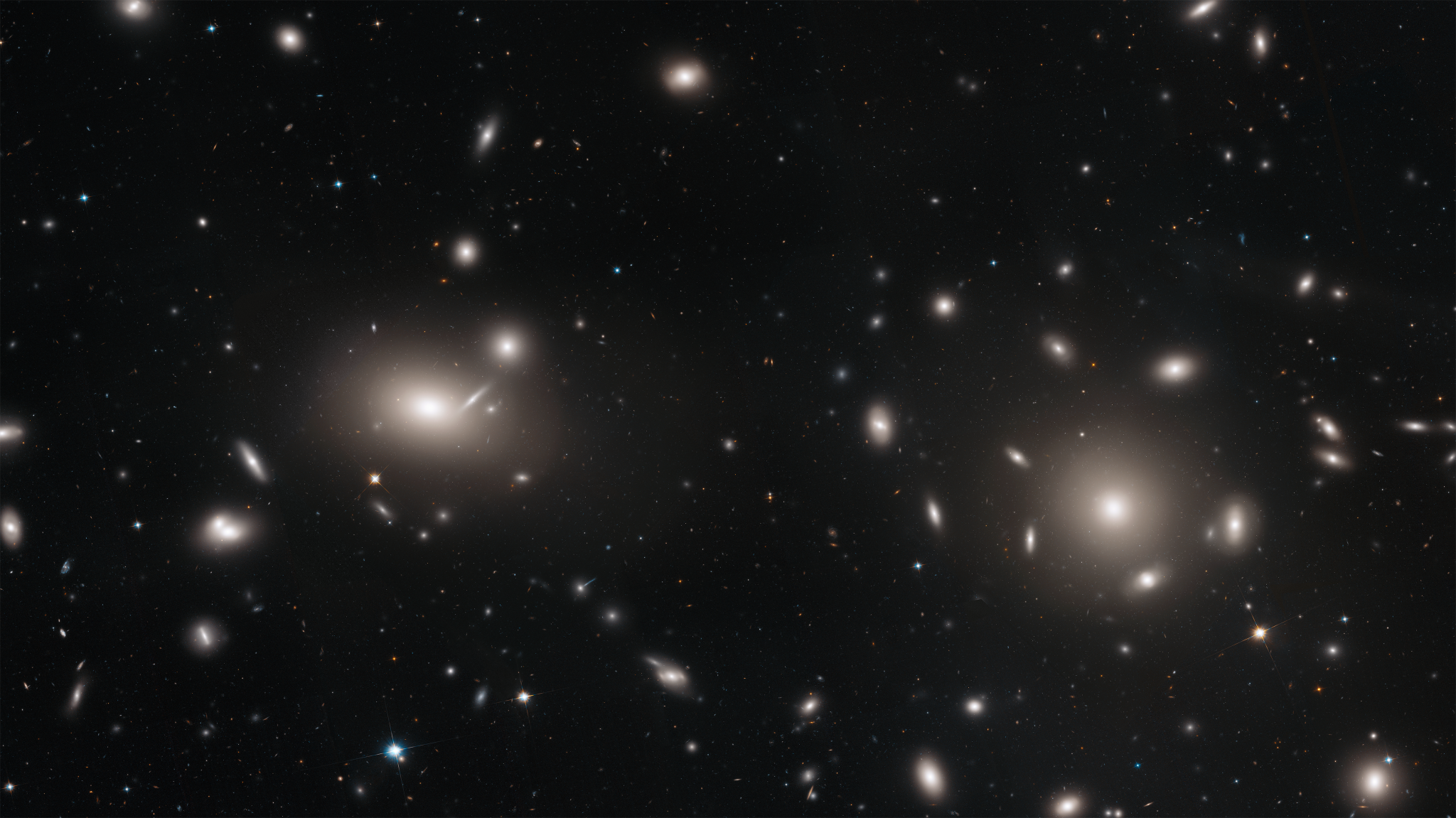 Entangled among the galaxies in this Hubble image are mysterious-looking arcs of blue light. 