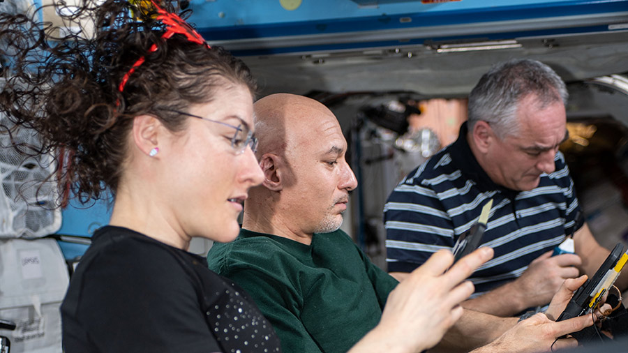 Expedition 61 crewmates Christina Koch, Luca Parmitano and Alexander Skvortsov practice emergency response skills aboard the space station. Image Credit: NASA