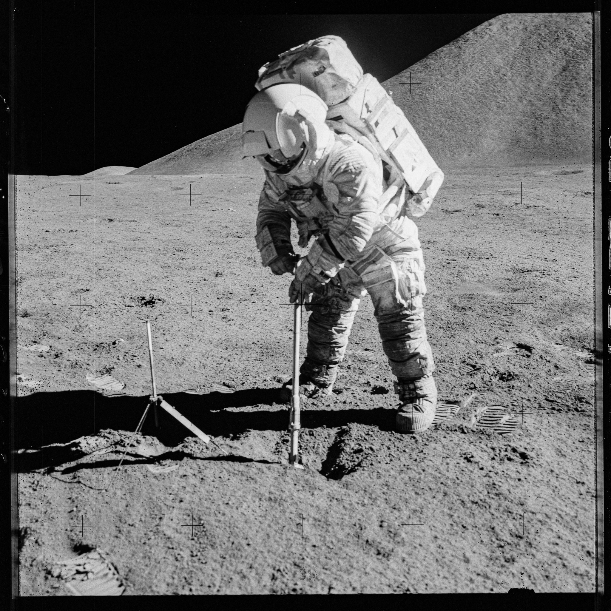 Black and white photo of astronaut spacesuit covered in moon dust