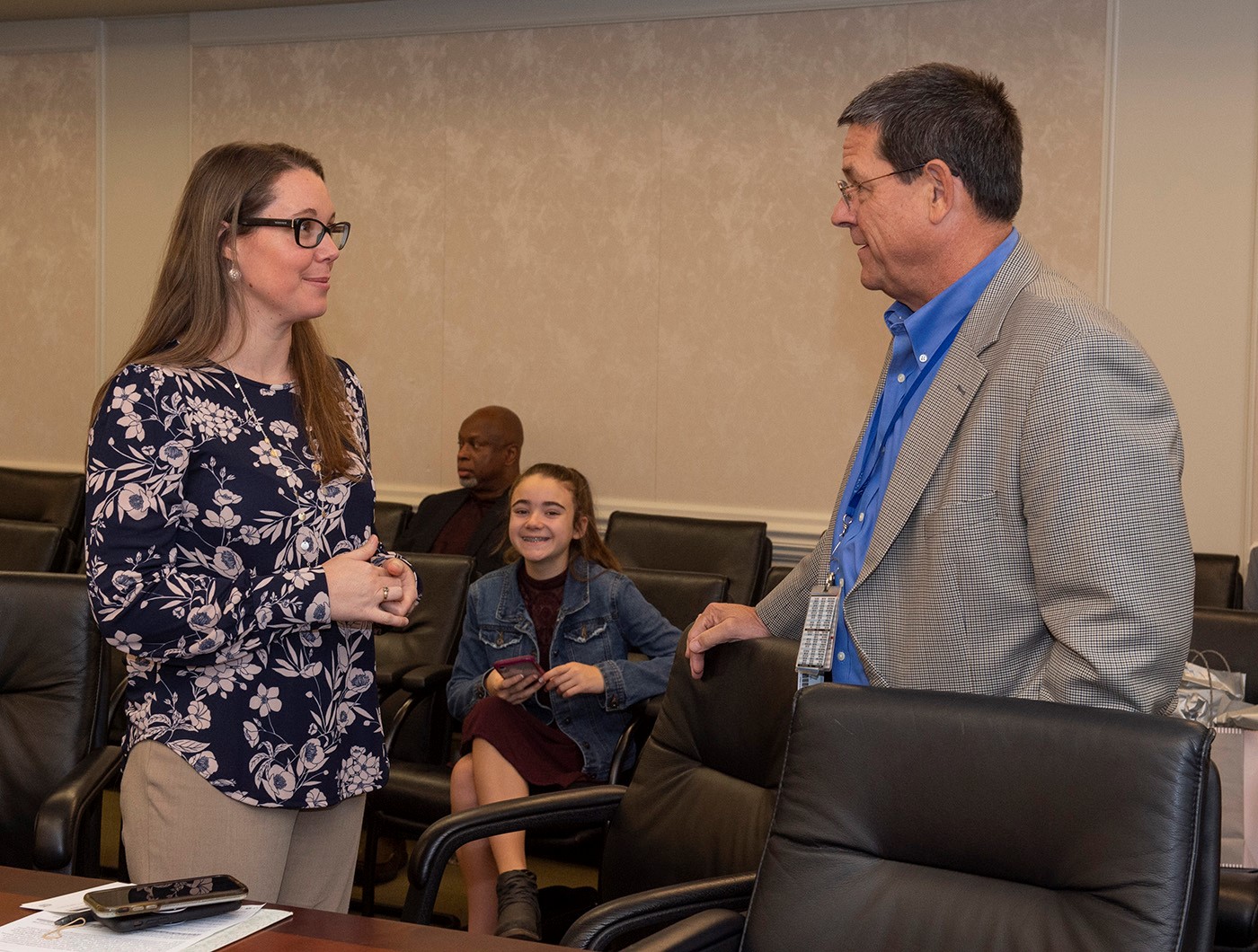 Tara Astigarraga, left, chats with Roy Malone after her Native American Heritage Month presentation at Marshall on Nov. 6