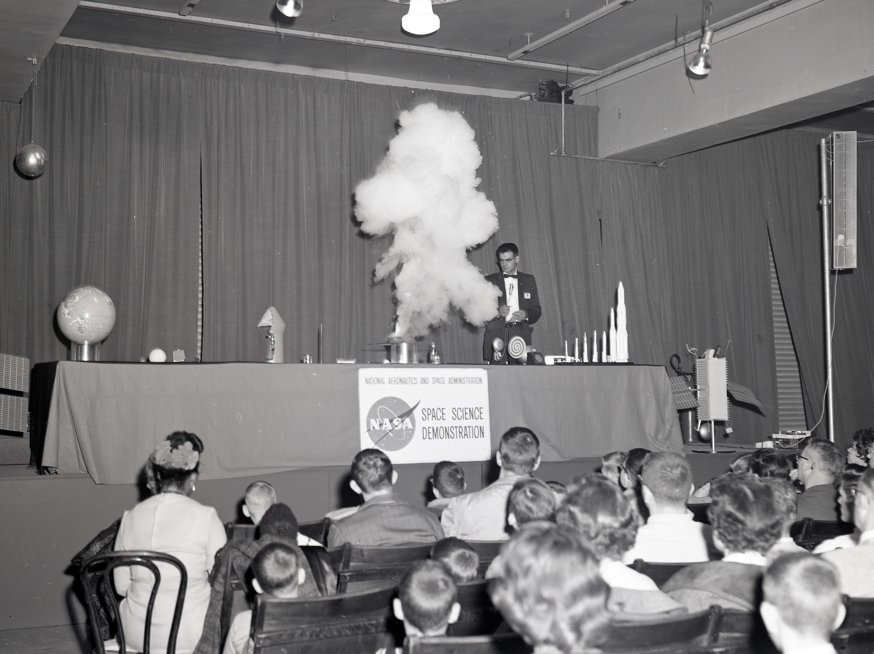 NASA scientists demonstrated scientific concepts for an audience of adults and students.