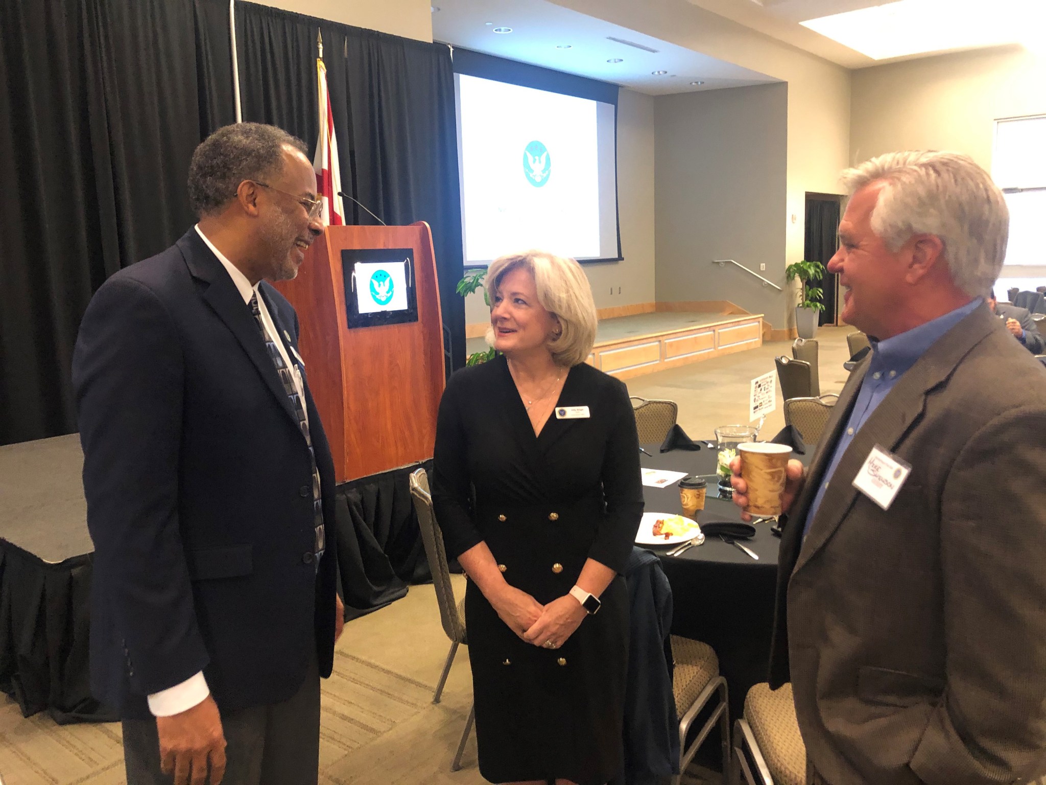 Jody Singer, center, talks with Charles Scales, of Sierra Lobo, left, and Mike Swenson following her address Nov. 19.