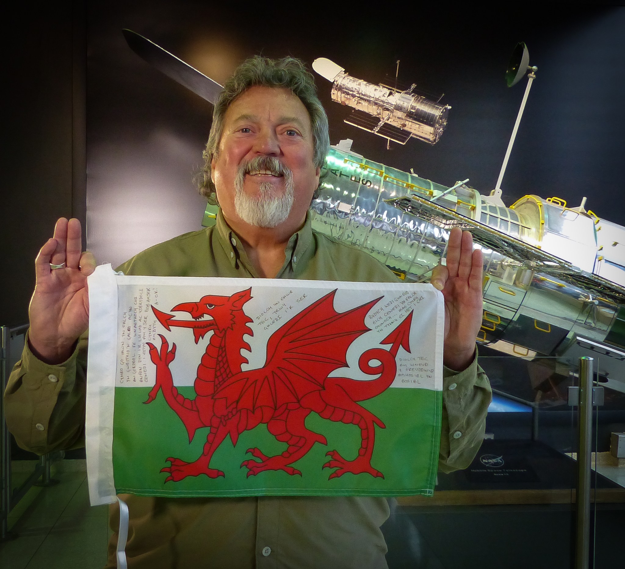man holding Welsh flag