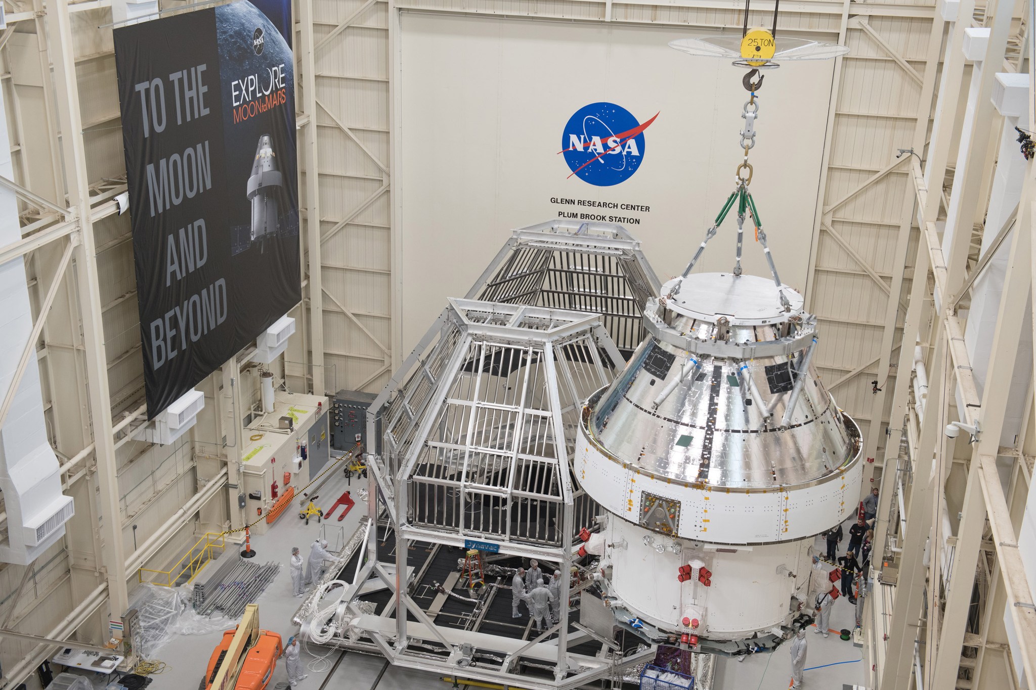 Orion spacecraft being moved with a crane into the Heat Flux System
