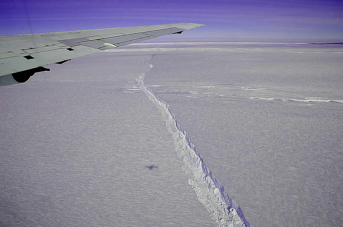A photo from the window of NASA's DC-8 shows the rift across the Pine Island Glacier ice shelf running off toward the horizon. T