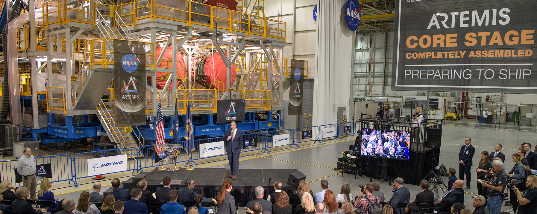 People in front of a rocket