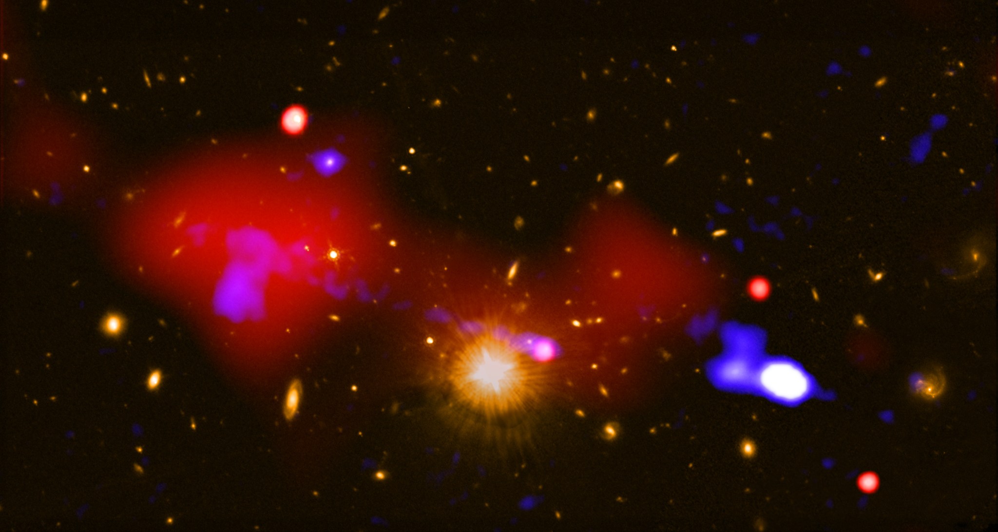 An image that contains a black hole that is triggering star formation across the longest distance ever seen.