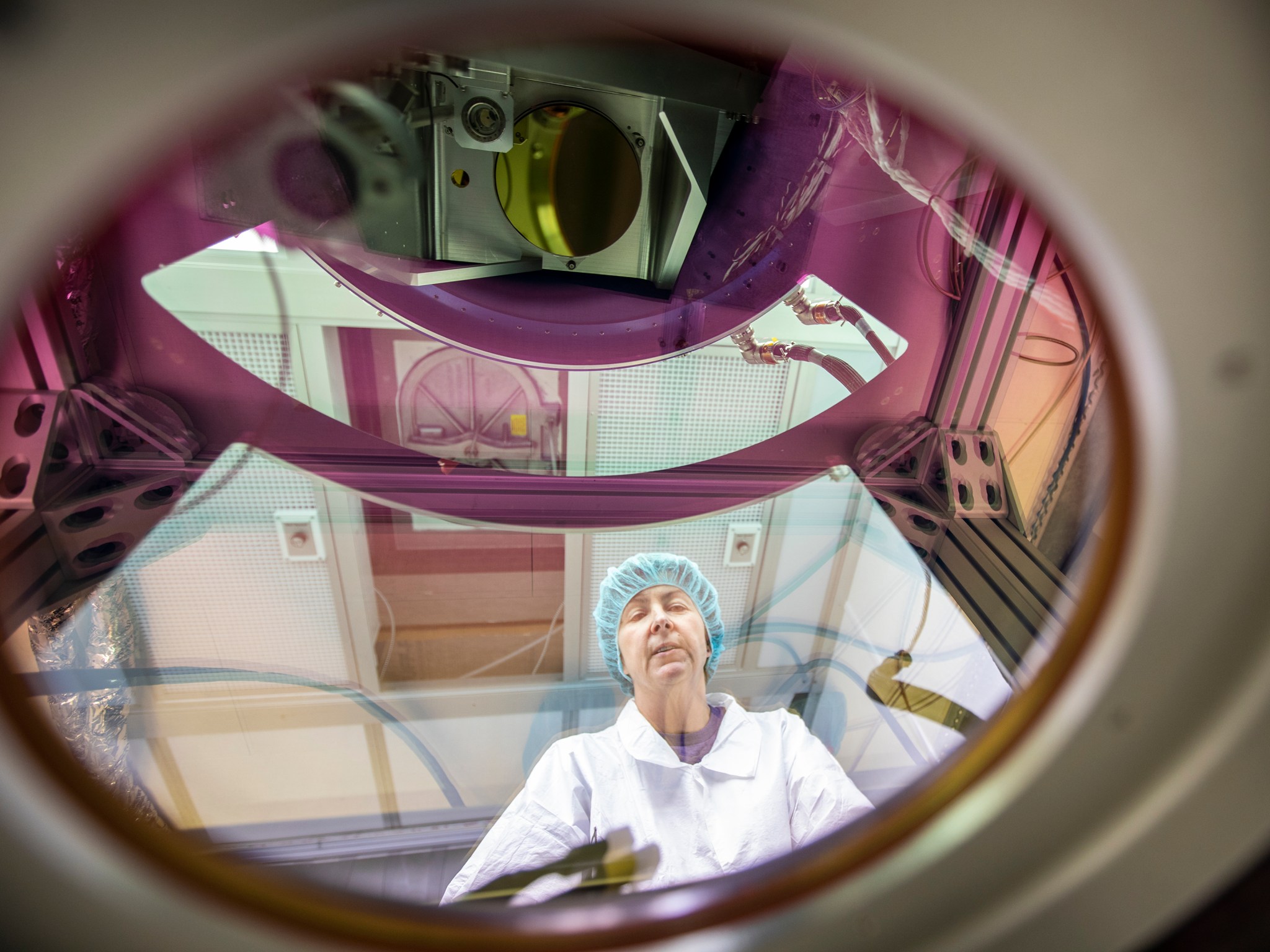 Electronics technician Anna Noe makes final checks to the Doppler Aerosol Wind Lidar (DAWN)