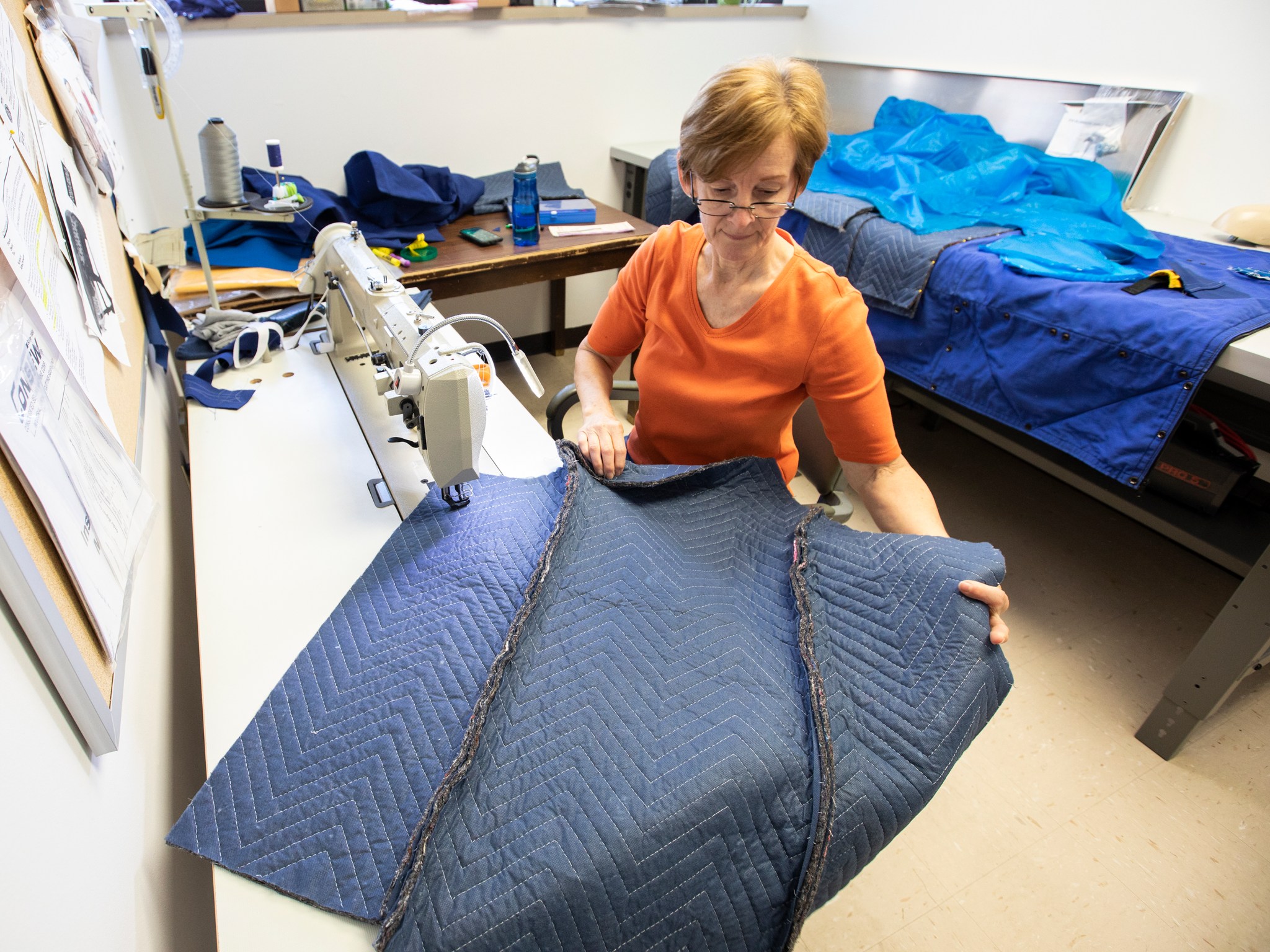 Crystal Chamberlain, technician at NASA Langley, works in a sewing lab to piece together a radiation protection vest prototype.