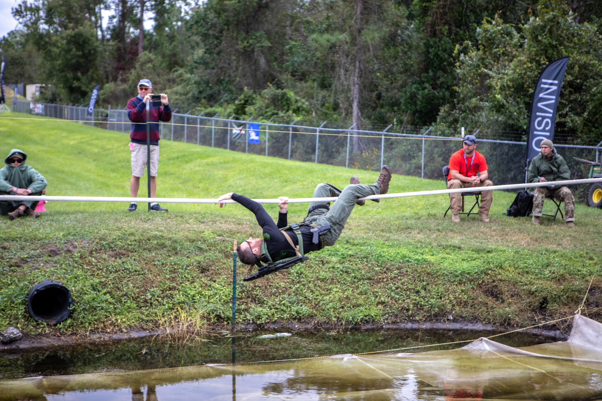 An ERT member moves along a rope above water during the annual SWAT Round-Up International.