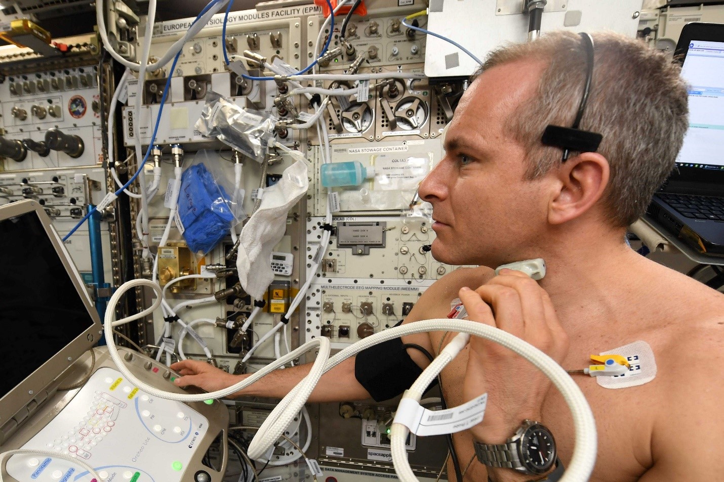 astronaut David Saint-Jacques performs an ultrasound on himself inside the space station