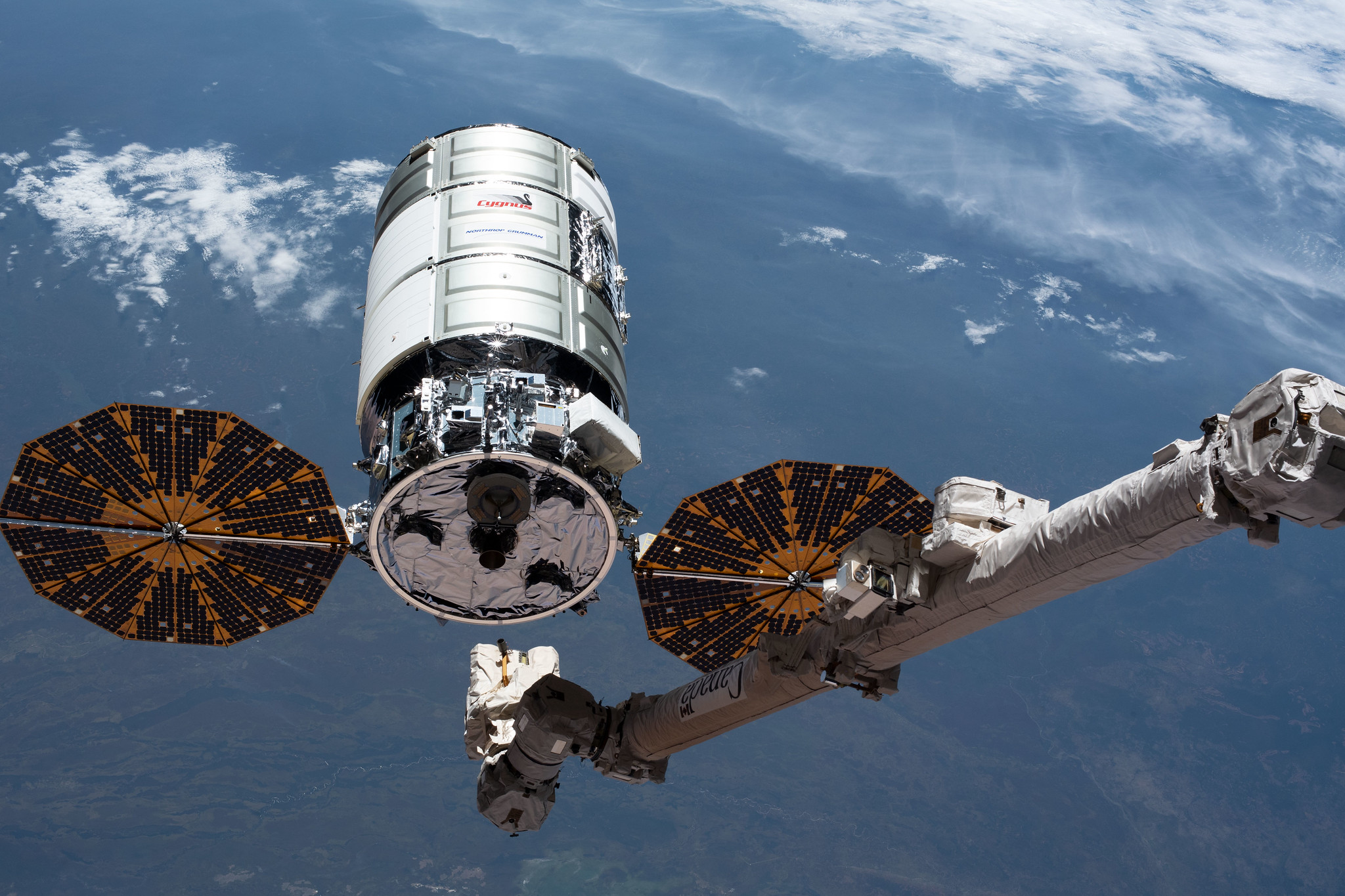 The U.S. Cygnus space freighter is pictured as the Canadarm2 robotic arm