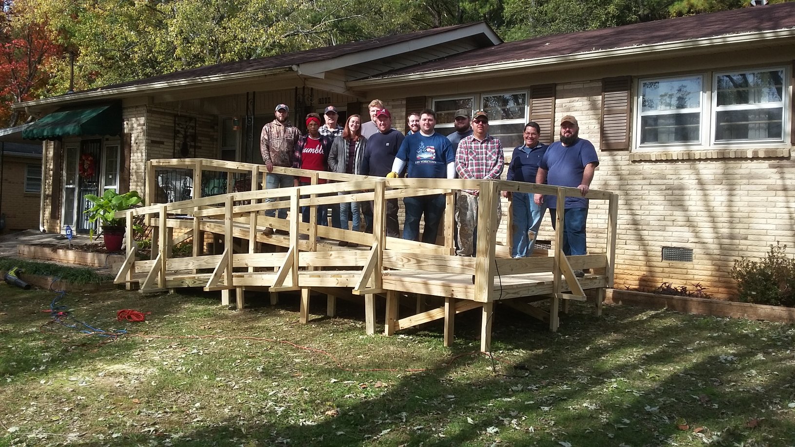 Team members complete a ramp as a project for the Care and Assurance System for the Aging and Homebound of Madison County.