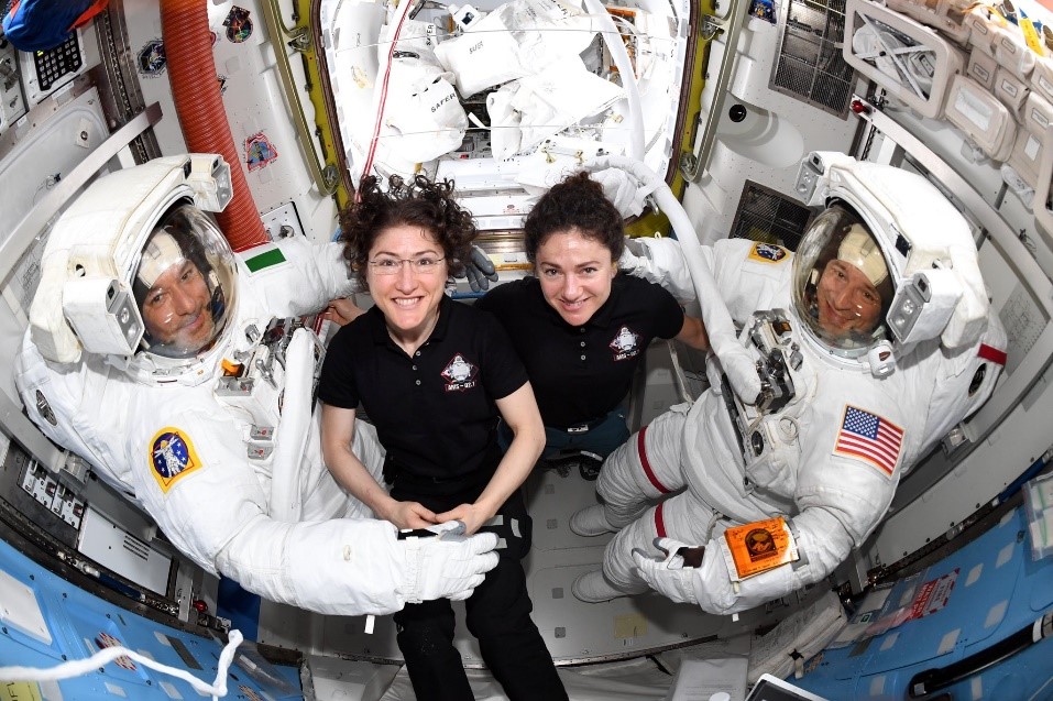 Astronauts Luca Parmitano, left, and Andrew Morgan, far right, joined above by Christina Koch, center left, and Jessica Meir. 