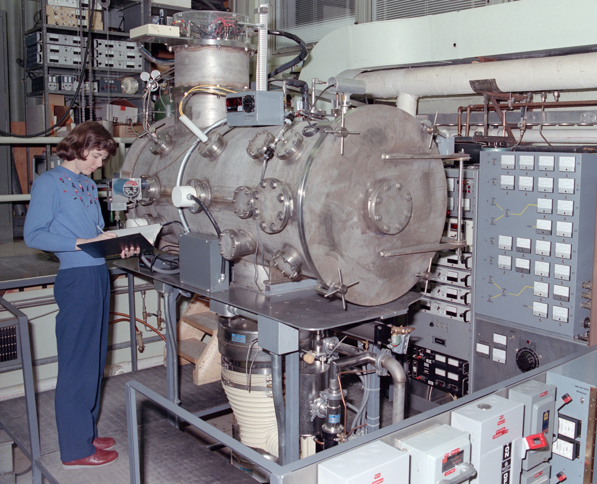 Researcher monitoring a test in a vacuum chamber.