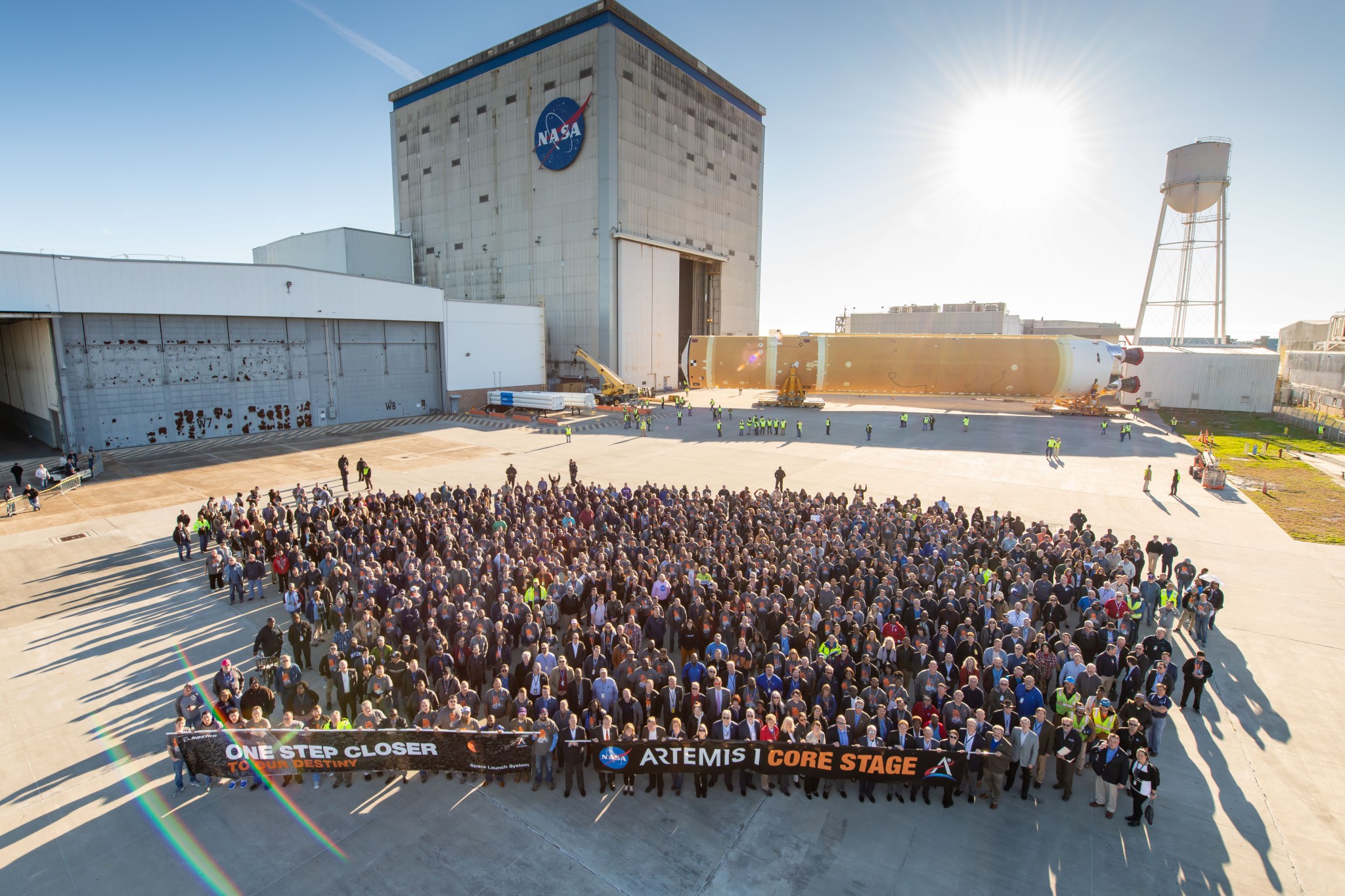 NASA personnel in front of the fully assembled core stage for NASA’s Space Launch System rocket