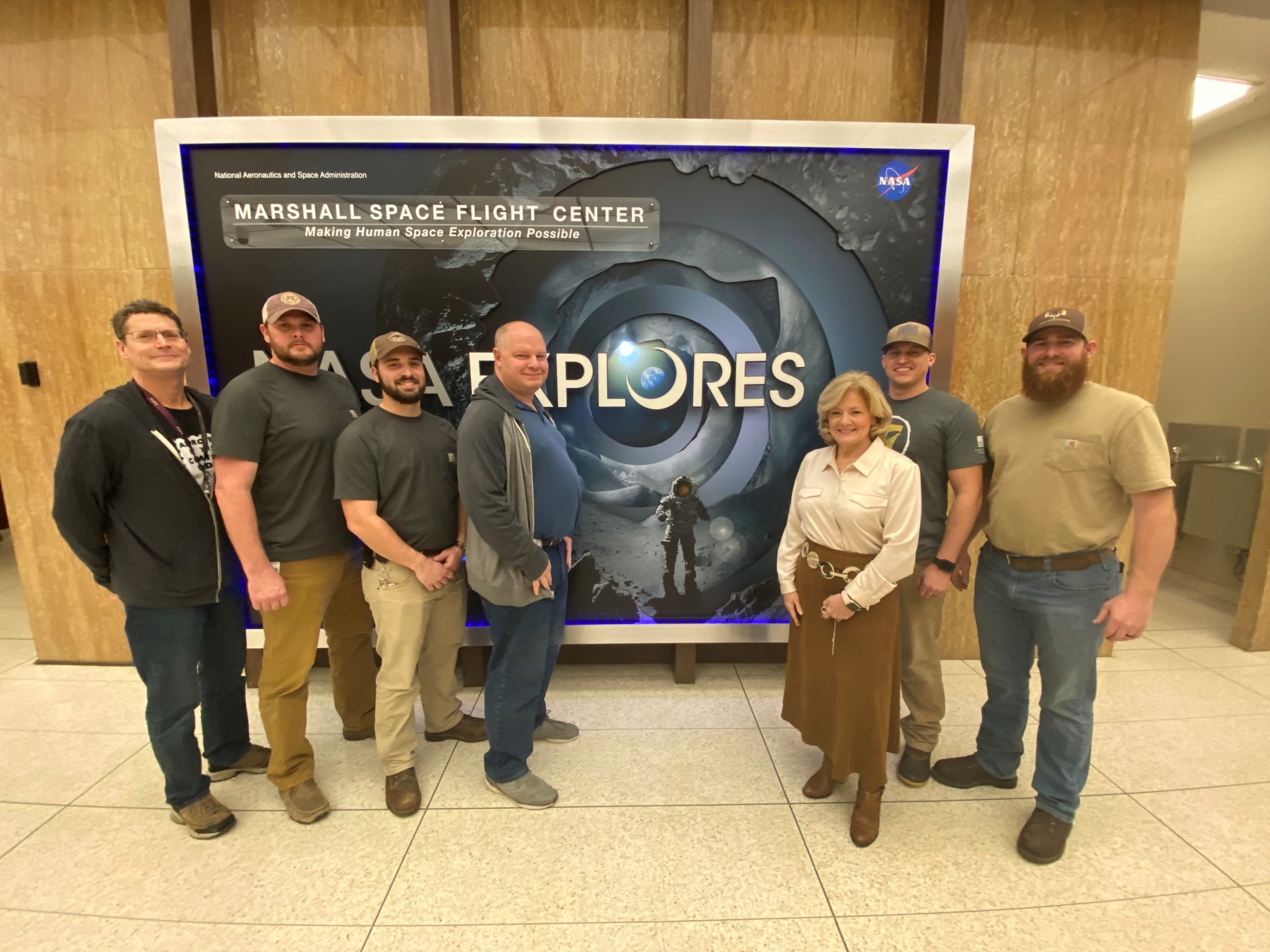 NASA’s Marshall Space Flight Center Director Jody Singer, center right, admires the new “NASA Explores” mural in Building 4200.