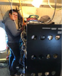 Sebastian Rainer of the National Suborbital Research Center (NSRC) works on the P-3 during IMPACTS integration.