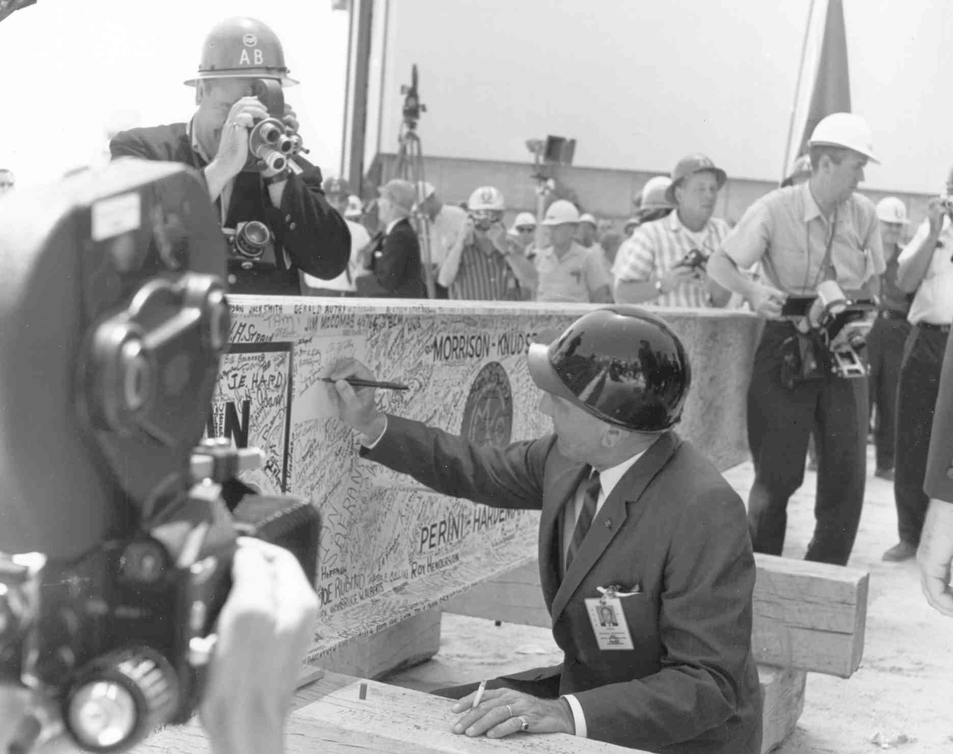 Dr. Kurt H. Debus, Kennedy Space Center’s first director, adds his name to the steel beam used in the VAB topping off ceremony.