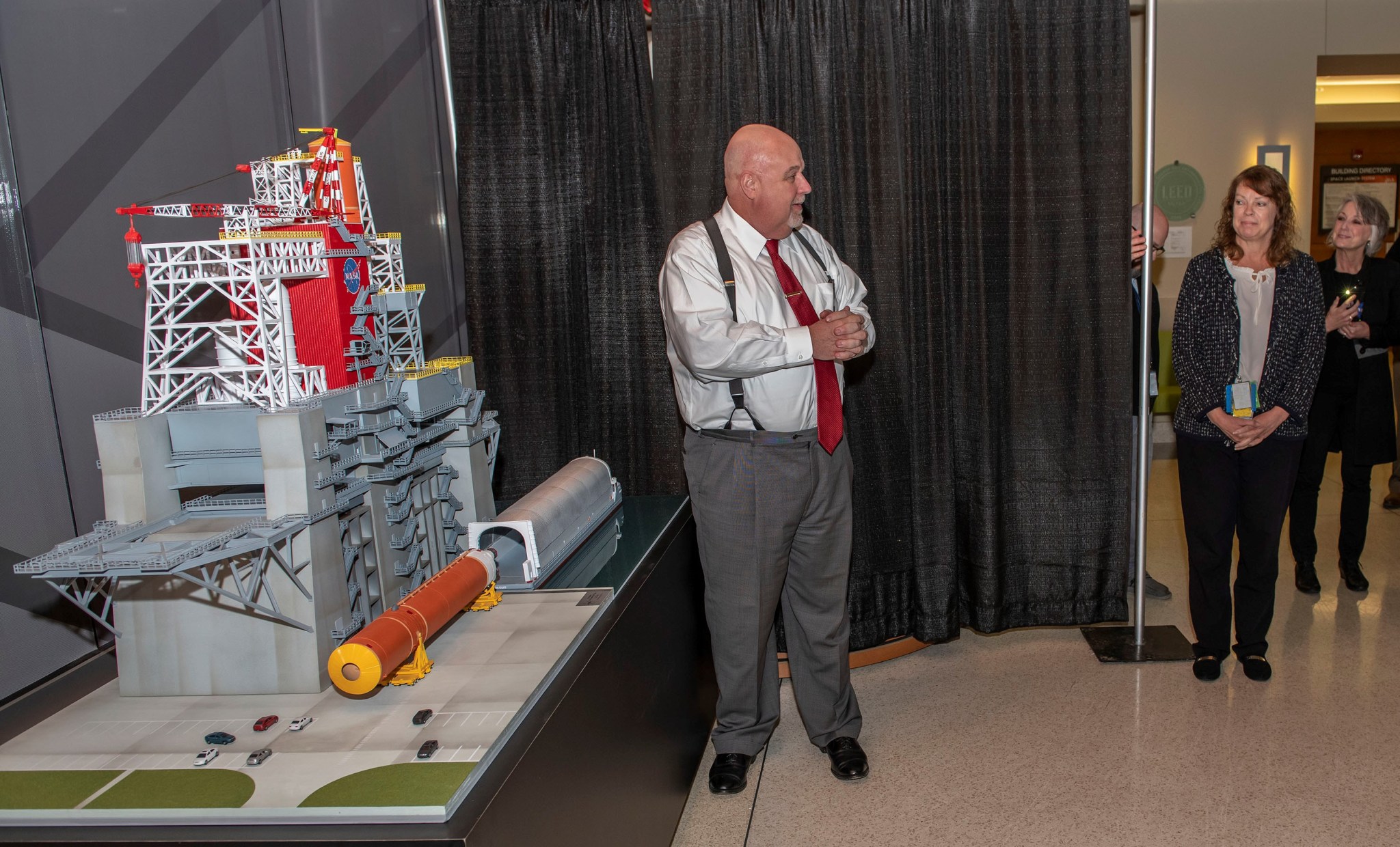 Man standing beside a test stand model