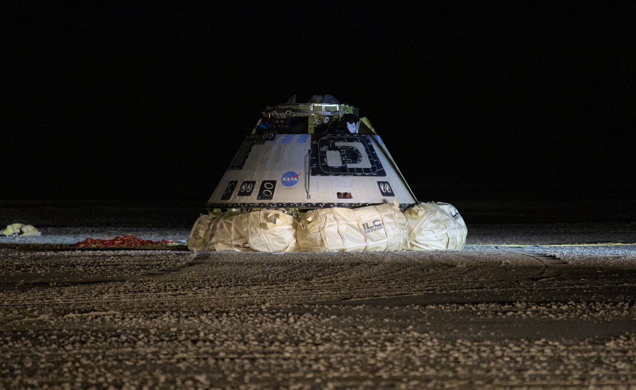 The Boeing CST-100 Starliner spacecraft is seen resting on its airbags after it landed in White Sands, New Mexico, Sunday, Dec.
