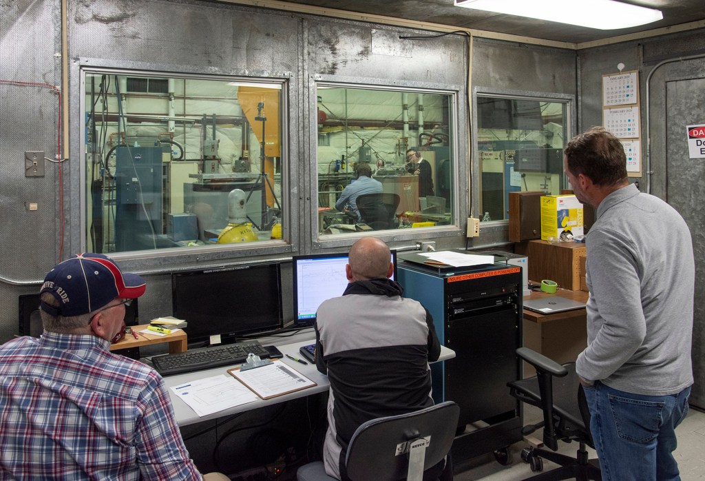 Engineers monitor data during vibration testing of a cruise motor controller for the X-57 Maxwell.