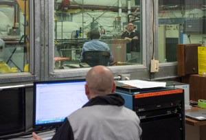 Engineers monitor data during vibration testing of a cruise motor controller for the X-57 Maxwell.
